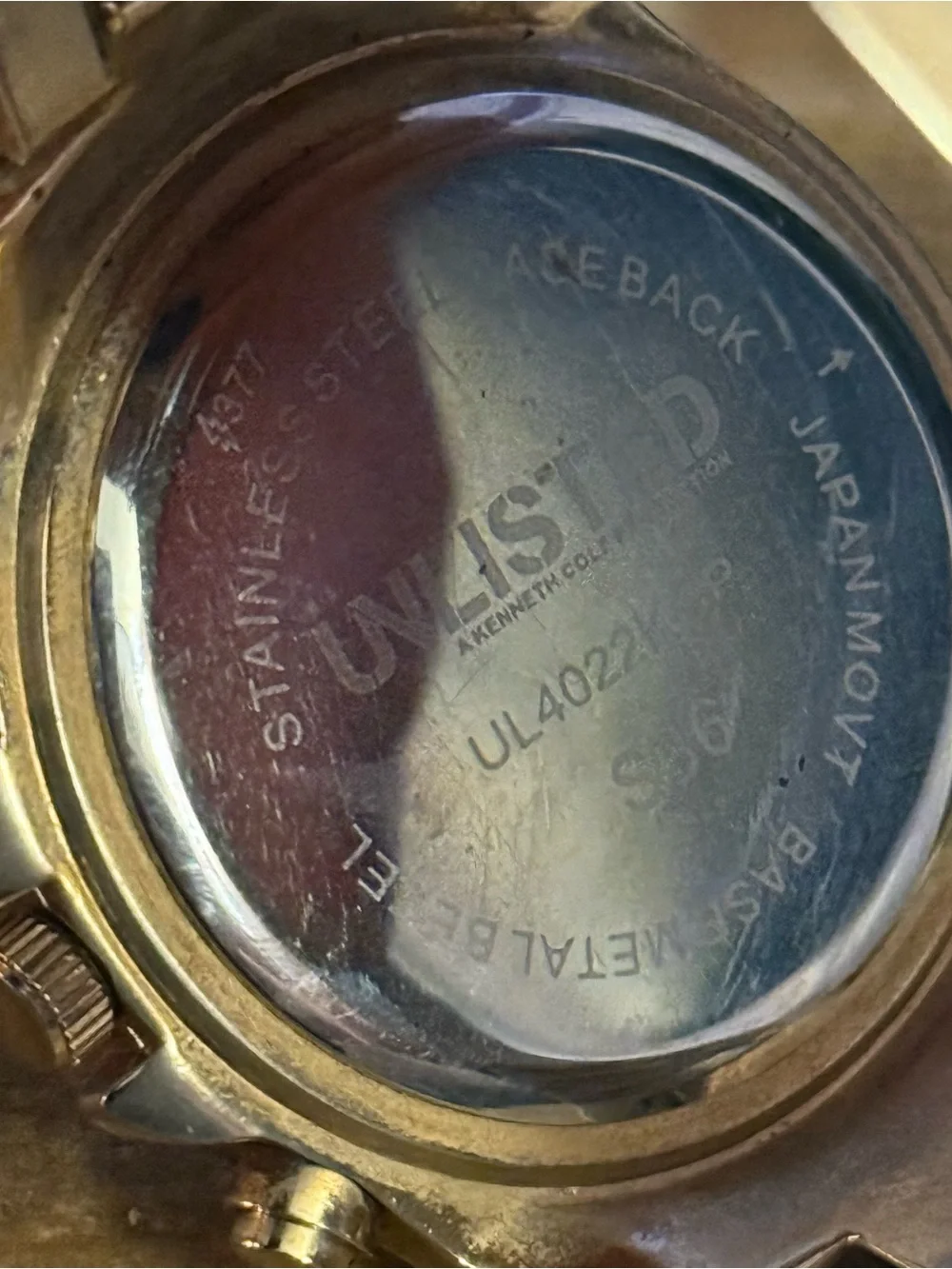 Unlisted by Kenneth Cole gold stainless steel crystal bezel watch